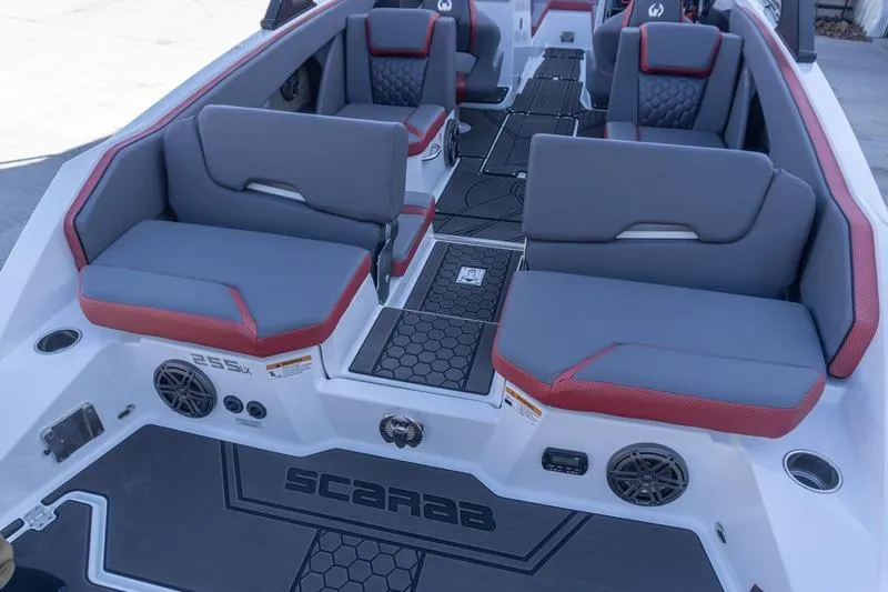 Slide: The Image of 2026 Scarab 255 LX Wake boat interior with gray and red seating. - 31