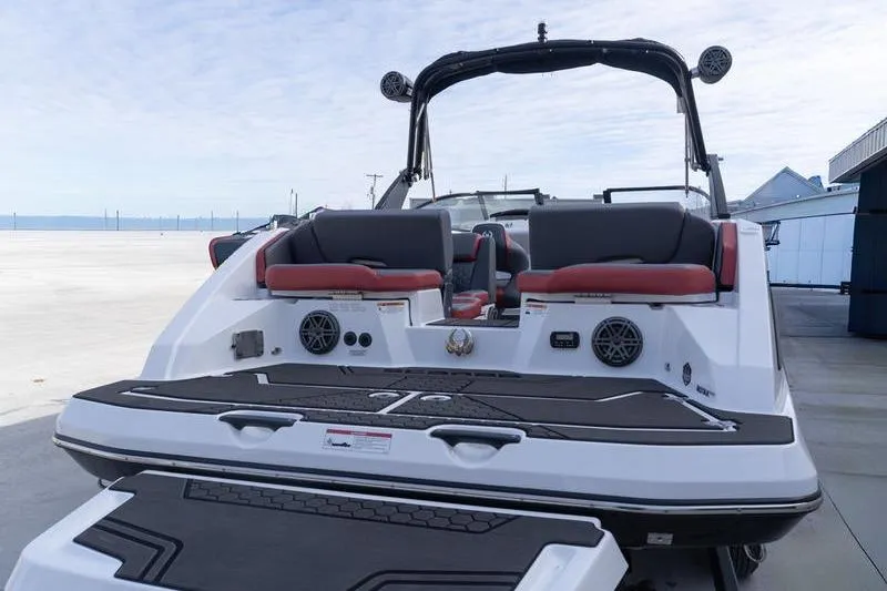 Slide: The Image of 2026 Scarab 255 LX Wake boat, rear view, featuring sleek design and modern seating. - 32