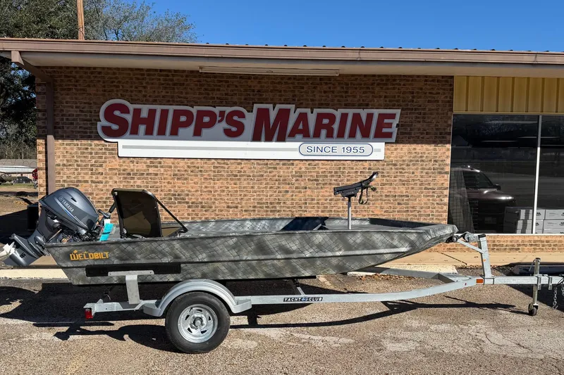 The Image of 2025 WeldBilt 1448 boat on trailer outside Shipp's Marine store. - 1