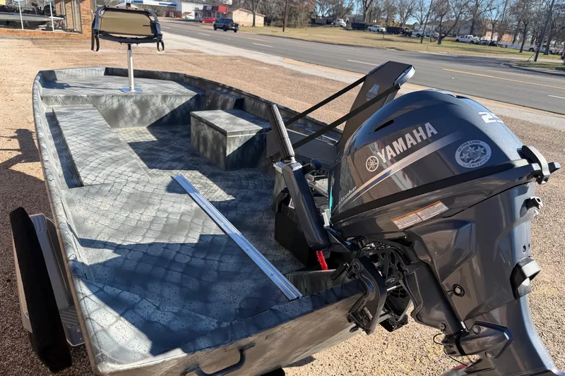 Slide: The Image of 2025 WeldBilt 1448 boat with Yamaha outboard motor, parked on roadside. - 8