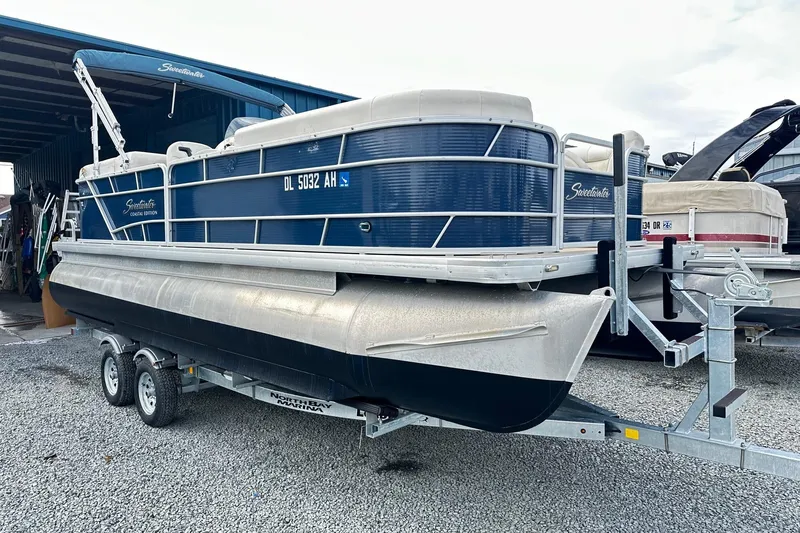 The Image of 2015 Godfrey 2286 Sweetwater Pontoon on trailer, parked in marina lot. - 0