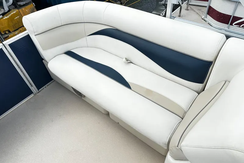 Slide: The Image of 2015 Godfrey 2286 Sweetwater Pontoon boat seating with white and navy upholstery. - 10