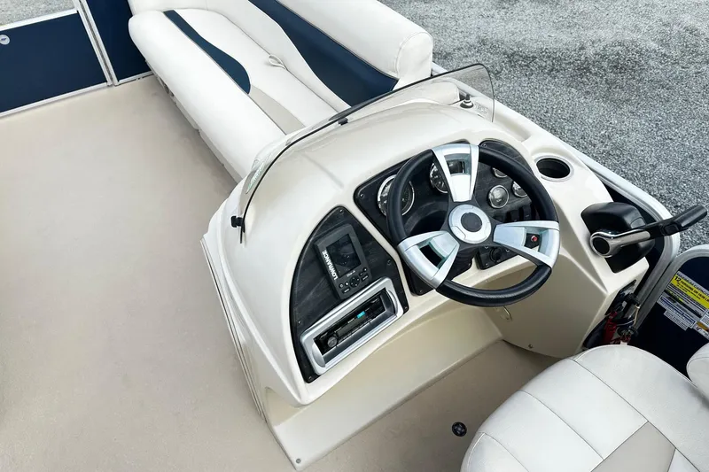 Slide: The Image of 2015 Godfrey 2286 Sweetwater Pontoon boat interior with steering console and seating. - 4