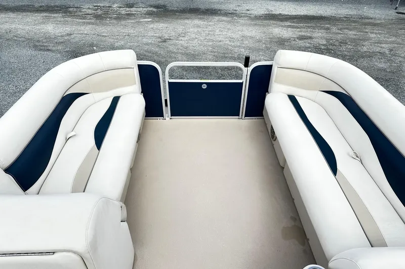 Slide: The Image of 2015 Godfrey 2286 Sweetwater Pontoon interior with white and blue seating. - 8