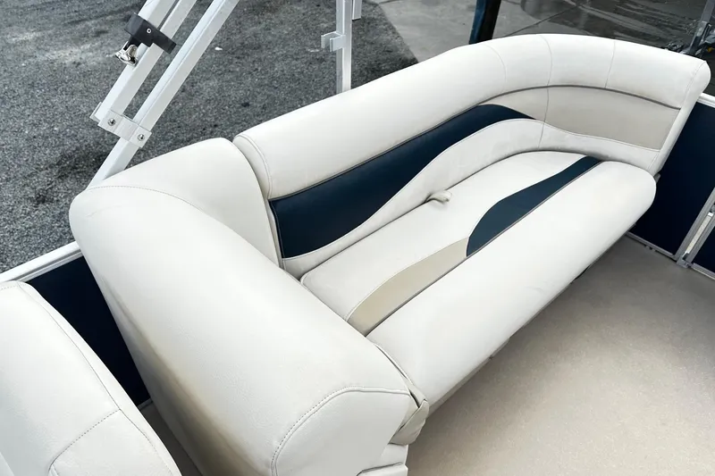Slide: The Image of 2015 Godfrey 2286 Sweetwater Pontoon boat interior with white and navy seating. - 9