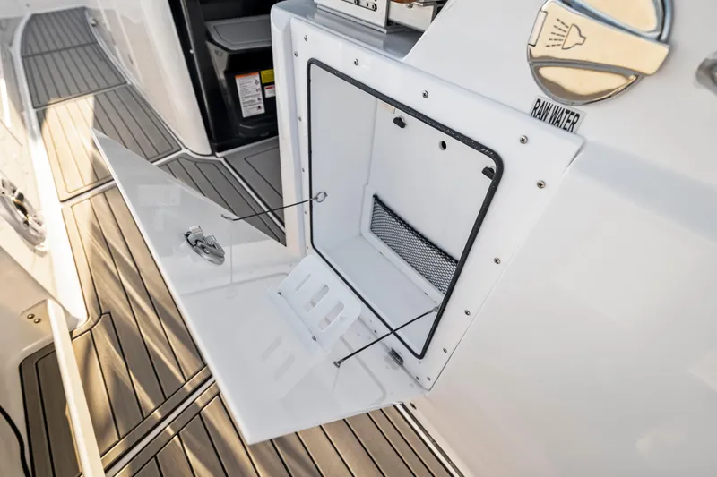 Slide: The Image of 2026 Everglades 375 Center Console boat with open storage compartment and raw water access. - 10