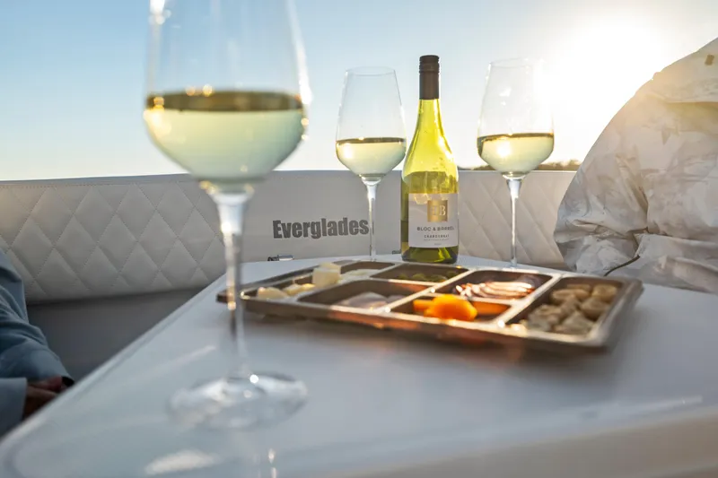 Slide: The Image of Wine and cheese on Everglades 375 Center Console boat, 2026 model, at sunset. - 11