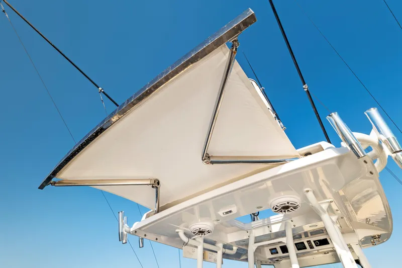 Slide: The Image of 2026 Everglades 375 Center Console boat canopy against clear blue sky. - 16