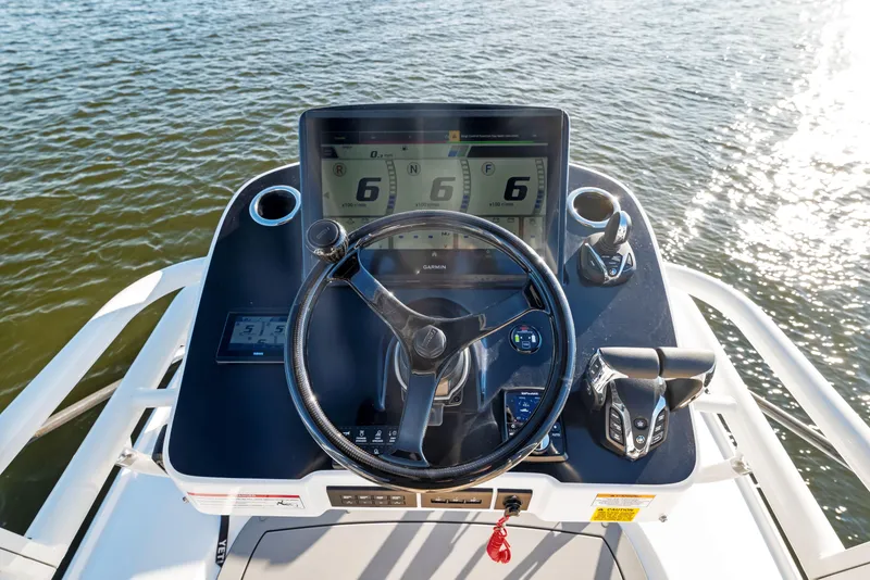 Slide: The Image of 2026 Everglades 375 Center Console boat helm with advanced navigation system on water. - 20