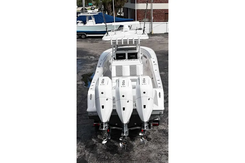 Slide: The Image of 2025 Invincible 36 Open Fisherman boat with triple 400 V10 engines, docked outdoors. - 17
