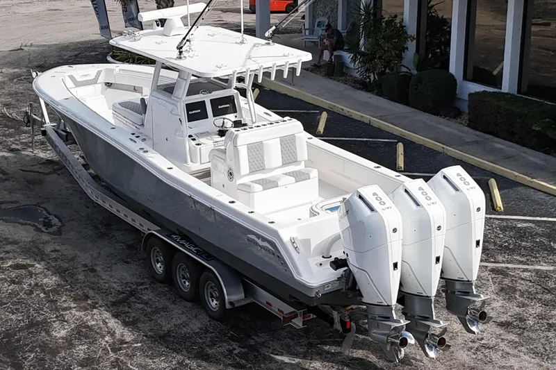 Slide: The Image of 2025 Invincible 36 Open Fisherman boat with triple outboard engines on a trailer. - 20