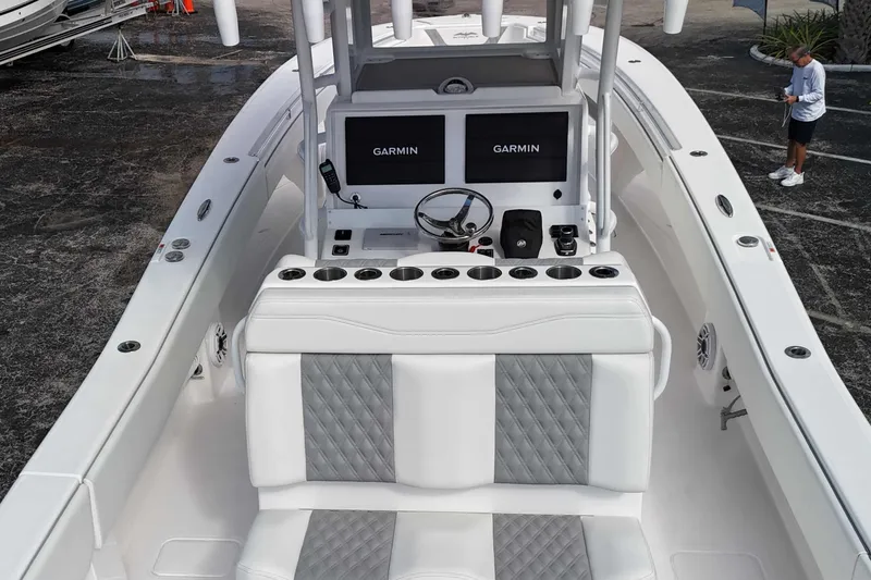 Slide: The Image of 2025 Invincible 36 Open Fisherman boat interior with Garmin displays and white seating. - 21