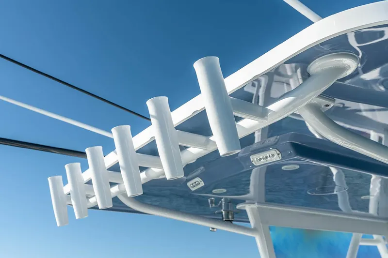Slide: The Image of Manufacturer Provided Image: 2025 Invincible 36 Open Fisherman boat, rod holders on sleek white roof against clear blue sky. - 7
