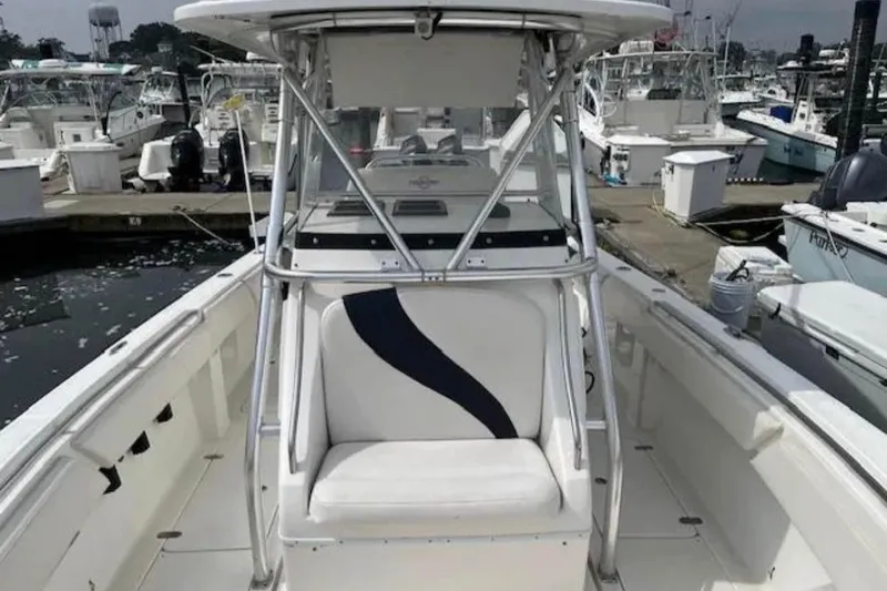 Slide: The Image of 2008 Fountain 34 Center Console boat docked at marina, featuring spacious seating and sleek design. - 5