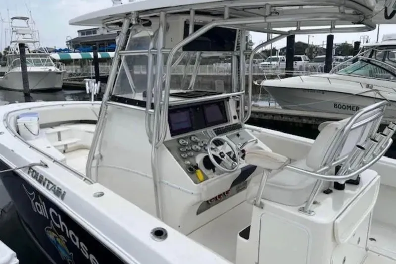 Slide: The Image of 2008 Fountain 34 Center Console boat with advanced navigation system, docked at marina. - 8