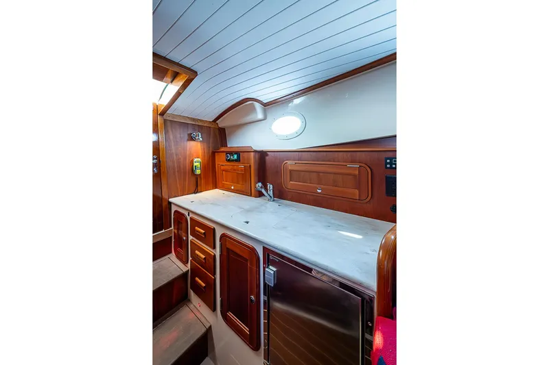 Slide: The Image of 2016 Hinckley Talaria 34 yacht interior with wooden cabinetry and sleek countertop. - 12