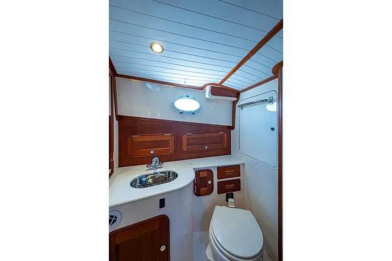 Slide: The Image of 2016 Hinckley Talaria 34 yacht bathroom with wood accents and modern fixtures. - 14