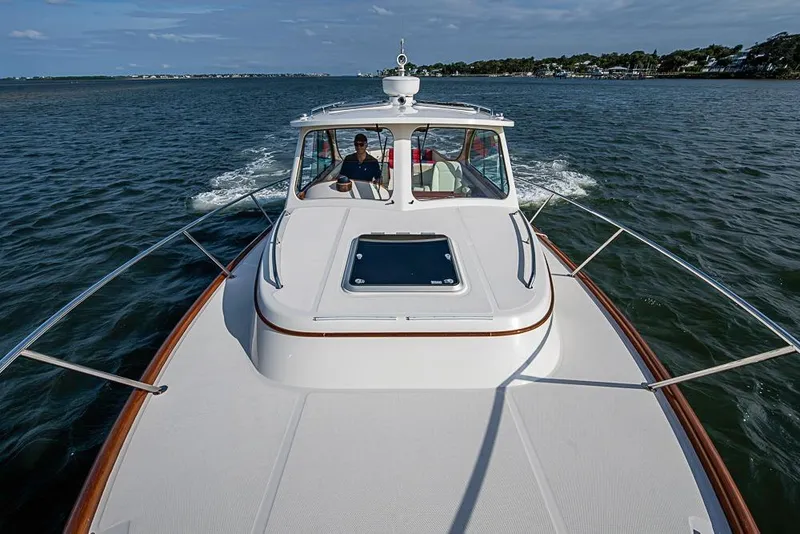 Slide: The Image of 2016 Hinckley Talaria 34 cruising on open water, showcasing elegant design and craftsmanship. - 18
