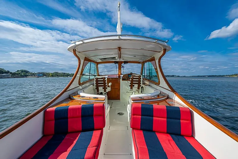 Slide: The Image of 2016 Hinckley Talaria 34 boat interior with striped seating, cruising on a sunny day. - 6