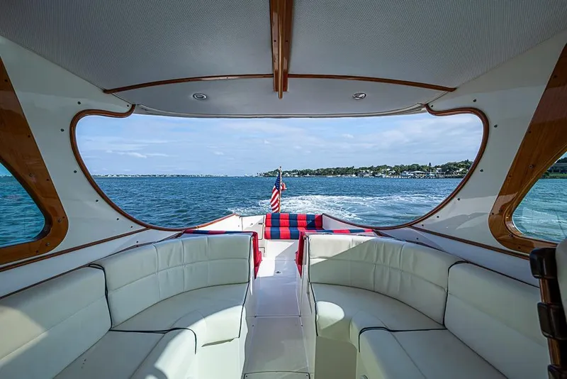 Slide: The Image of Interior view of 2016 Hinckley Talaria 34 yacht with white seating and ocean backdrop. - 7