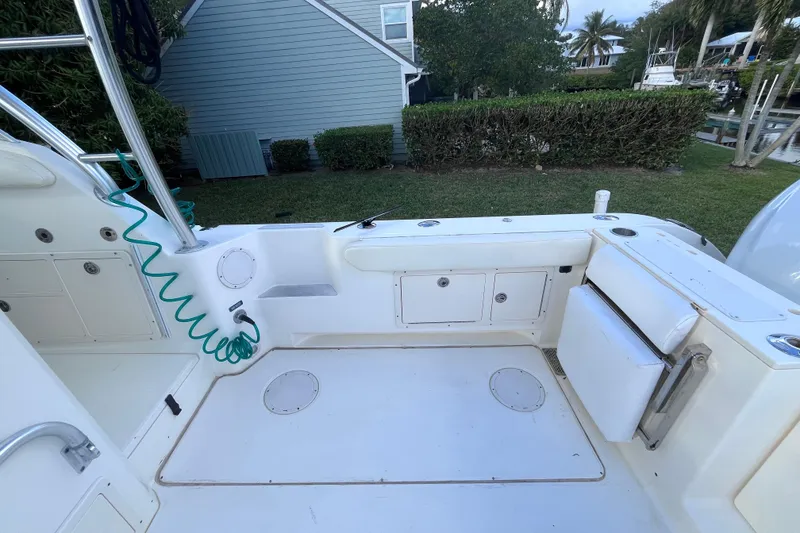 Slide: The Image of 2010 World Cat 290 EC boat deck with seating and storage compartments. - 13