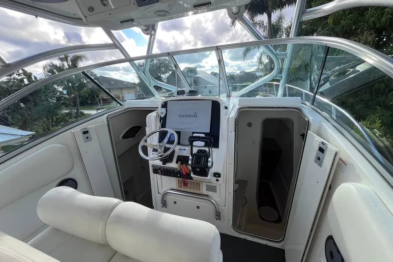 Slide: The Image of 2010 World Cat 290 EC boat cockpit with Garmin navigation system and plush seating. - 17