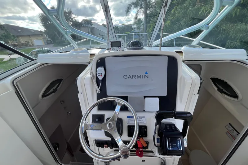 Slide: The Image of 2010 World Cat 290 EC boat helm with Garmin navigation system. - 18