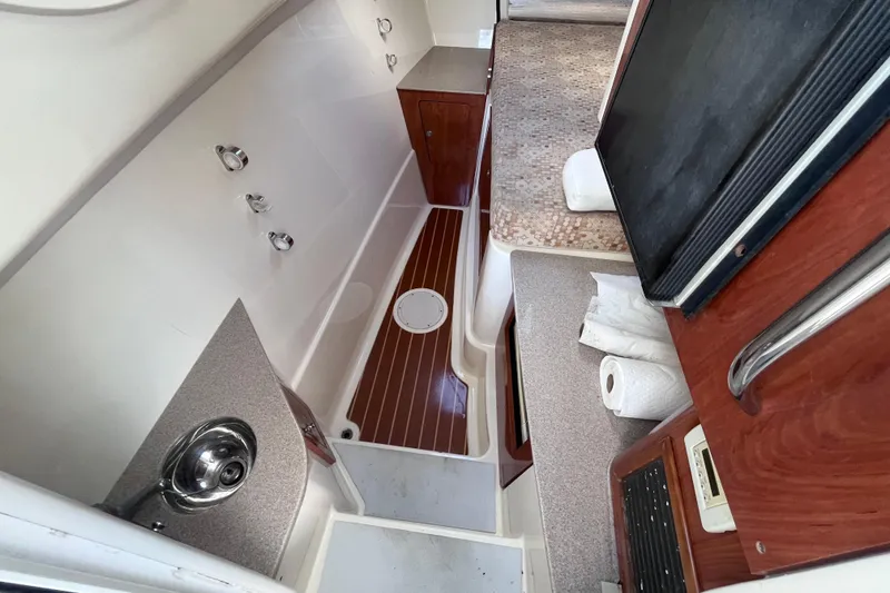 Slide: The Image of 2010 World Cat 290 EC interior with sink, countertop, and wooden cabinetry. - 20