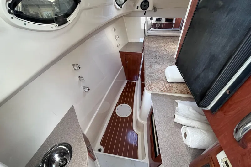 Slide: The Image of Interior of a 2010 World Cat 290 EC boat, featuring a compact cabin layout. - 21