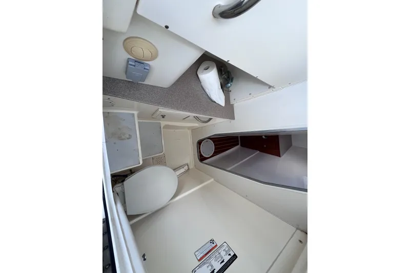Slide: The Image of 2010 World Cat 290 EC boat interior with toilet and storage area. - 24