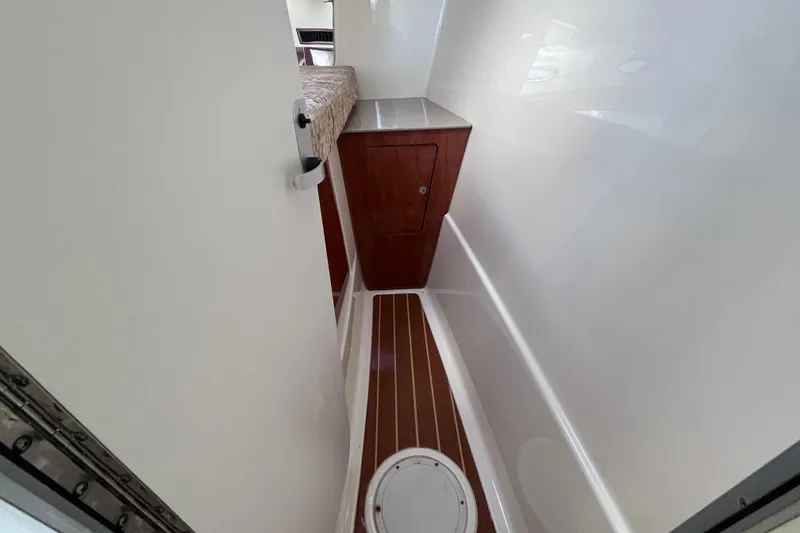 Slide: The Image of 2010 World Cat 290 EC interior cabin with wood flooring and storage compartment. - 25