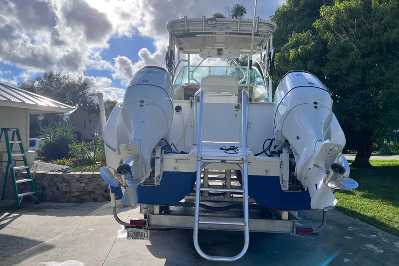 Slide: The Image of 2010 World Cat 290 EC boat with dual outboard motors on a trailer. - 3