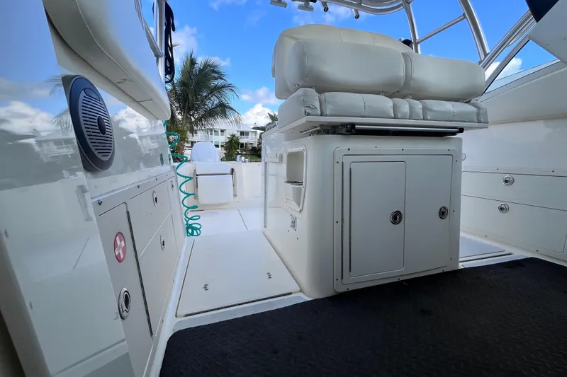 Slide: The Image of 2010 World Cat 290 EC boat interior with seating and storage, under a clear blue sky. - 30