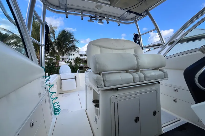 Slide: The Image of 2010 World Cat 290 EC boat interior with white seating and clear blue sky. - 31