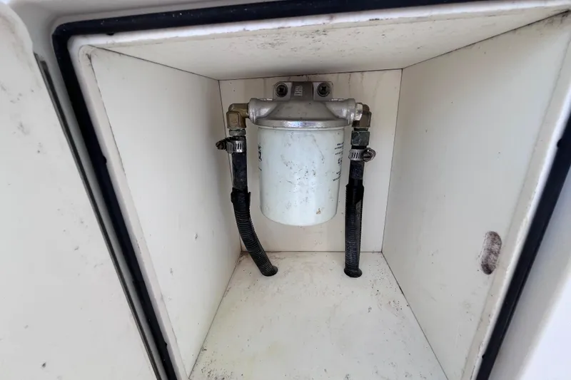Slide: The Image of Fuel filter system inside a 2010 World Cat 290 EC boat compartment. - 38
