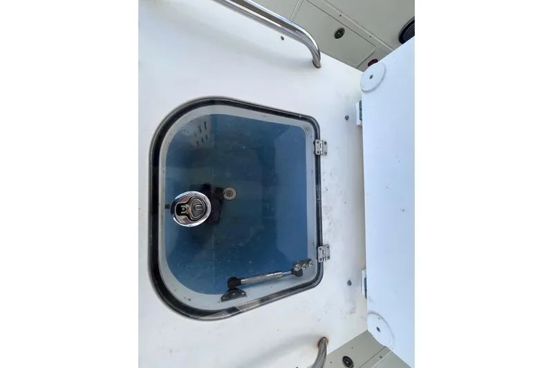 Slide: The Image of Livewell compartment on a 2010 World Cat 290 EC boat, featuring a secure latch. - 40