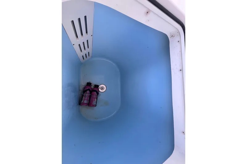 Slide: The Image of Livewell interior of 2010 World Cat 290 EC boat with bottles inside. - 41