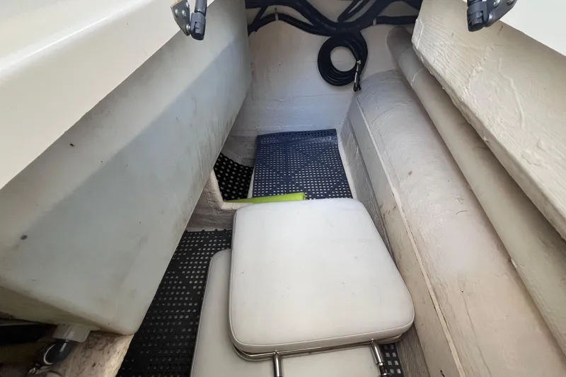 Slide: The Image of Interior of a 2010 World Cat 290 EC boat, featuring seating and storage area. - 44
