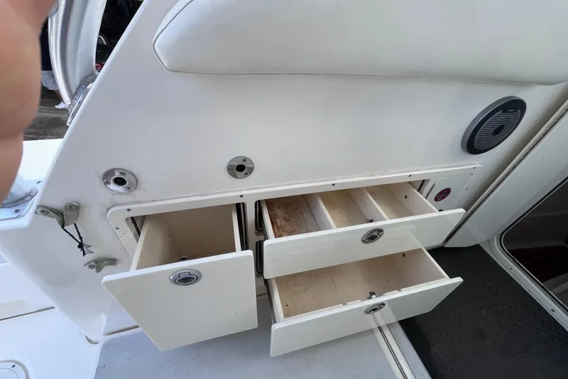 Slide: The Image of Open storage drawers on a 2010 World Cat 290 EC boat interior. - 49