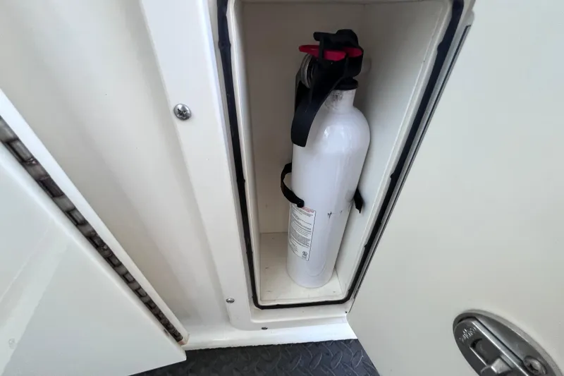 Slide: The Image of Fire extinguisher in compartment of 2010 World Cat 290 EC boat. - 53