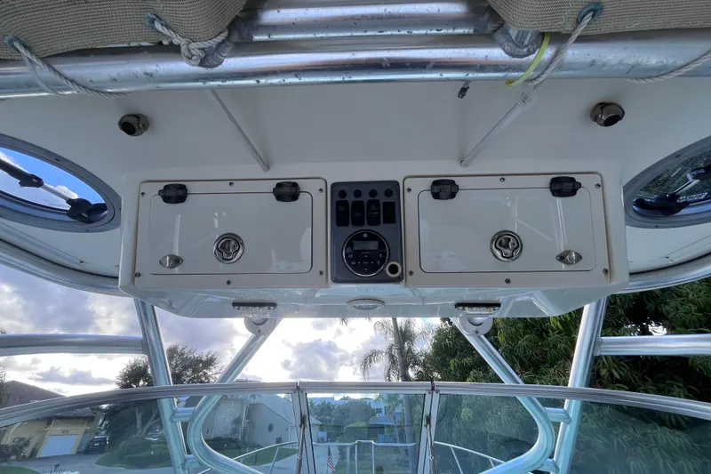 Slide: The Image of 2010 World Cat 290 EC boat dashboard with storage compartments and control panel. - 54