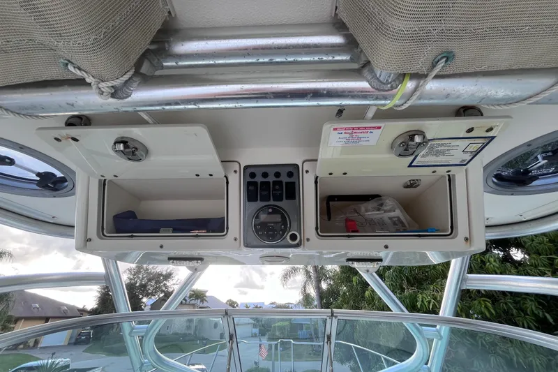 Slide: The Image of 2010 World Cat 290 EC boat dashboard with open storage compartments and control panel. - 55