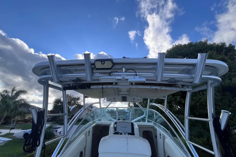 Slide: The Image of 2010 World Cat 290 EC boat with T-top and clear sky background. - 56