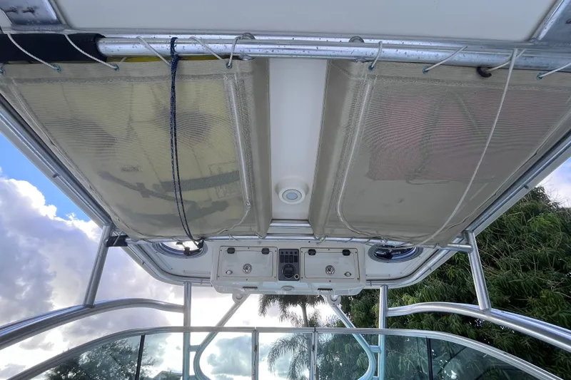 Slide: The Image of 2010 World Cat 290 EC boat interior view with overhead storage and control panel. - 58