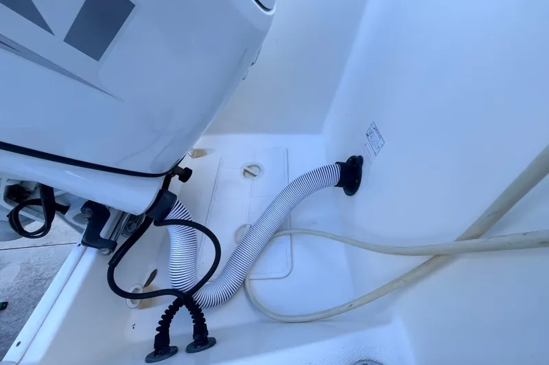 Slide: The Image of 2010 World Cat 290 EC boat engine compartment with hoses and fittings. - 61