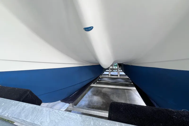 Slide: The Image of 2010 World Cat 290 EC boat hull on trailer, showcasing blue and white design. - 72