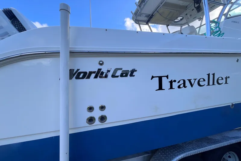 Slide: The Image of 2010 World Cat 290 EC boat with "Traveller" name, white and blue exterior. - 75