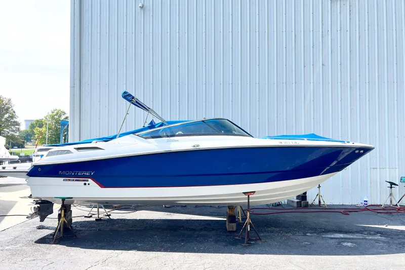 The Image of 2019 Monterey 298SS Super Sport boat in blue and white, docked outdoors. - 0