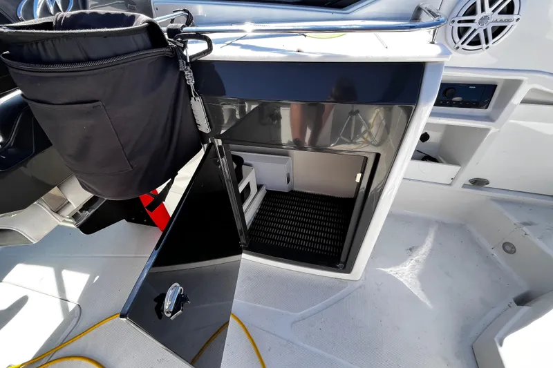 Slide: The Image of 2019 Monterey 298SS Super Sport boat interior with open storage compartment and speaker. - 21