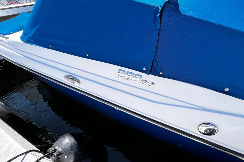 Slide: The Image of 2019 Monterey 298SS Super Sport boat with blue cover docked at marina. - 4